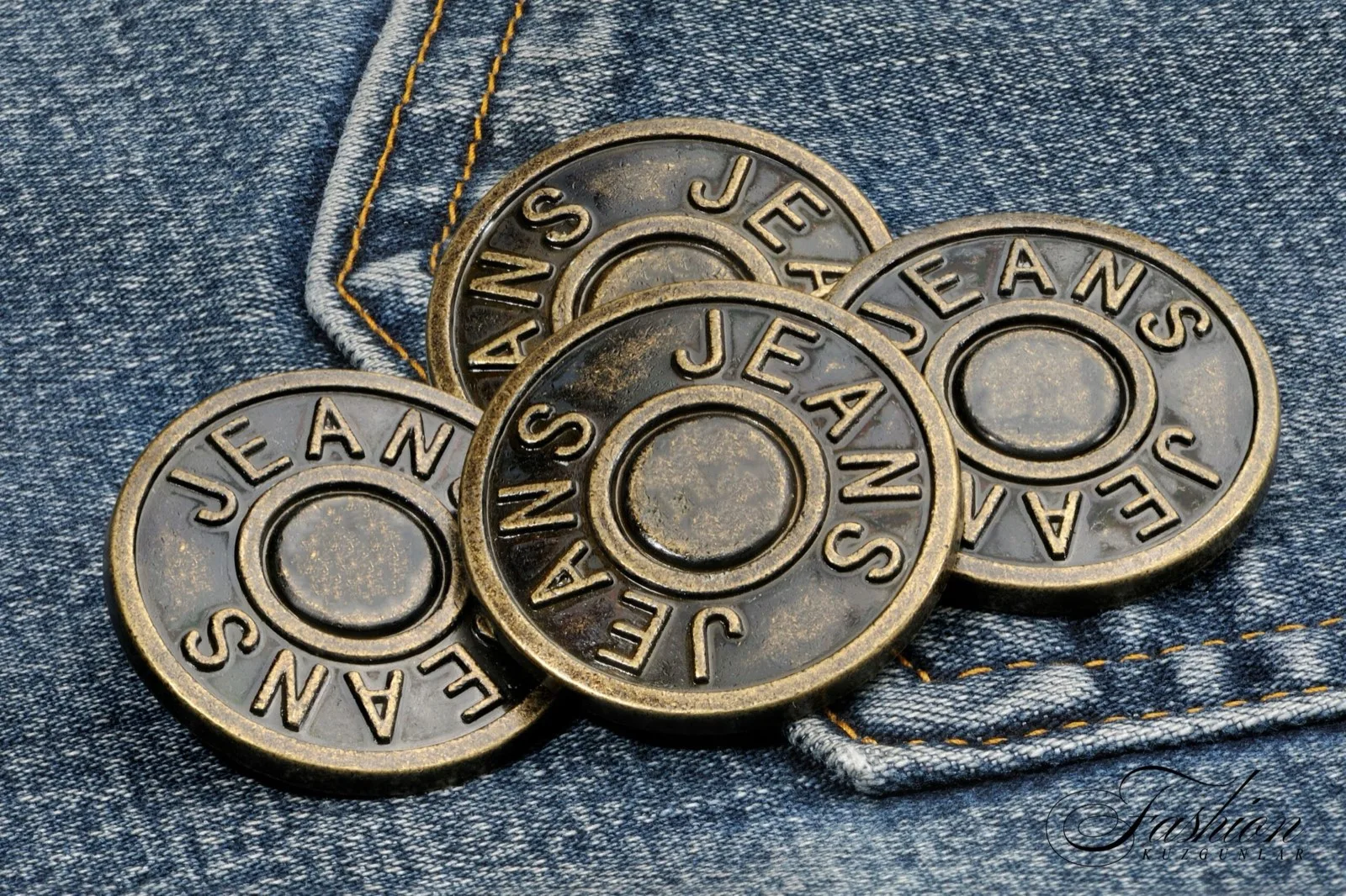 Metal jeans buttons on denim fabric