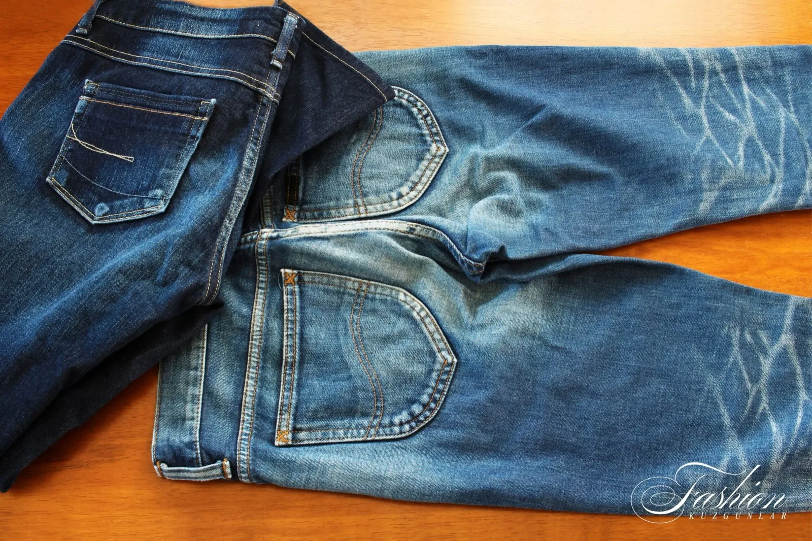 Dark-wash men's jeans with faded whiskers and back pockets